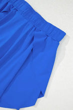 Royal blue pleated shorts with elastic waistband and ruffled hem
