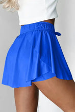 Royal blue pleated skater skirt with elastic waistband and bow detail