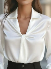 A sleek white satin ruched collared neck long sleeve blouse with distinctive front knot detail and classic collar