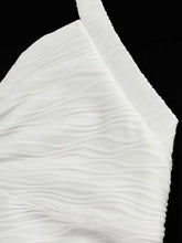 White crinkled fabric with soft texture and wave-like folds in ruched halter neck cami design