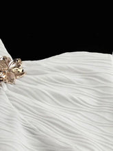 White pleated ruched halter neck cami with gold-toned floral embellishment on lightweight fabric