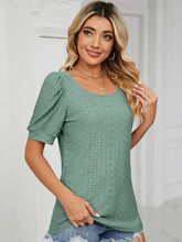 Woman in light green eyelet ruched notched long sleeve T-shirt