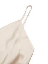 Cream-colored satin ruched spaghetti strap bodysuit with thin matching straps for a sleek strap bodysuit look