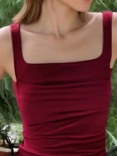 A fitted deep red ruched square neck tank top with sleeveless design and gathered fabric details