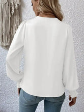 White ruched surplice blouse with long sheer sleeves and delicate ruffled cuffs made of lightweight fabric