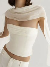 A delicate white chiffon scarf draped over the shoulders complements a ruched strapless corset tube top