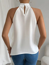White satin ruffle halter neck sleeveless blouse with keyhole back detail showcasing halter neck design
