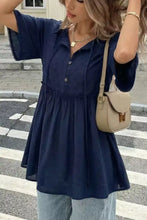 Navy blue embroidered blouse with short flutter sleeves and button-down front featuring ruffle hem tie neck design
