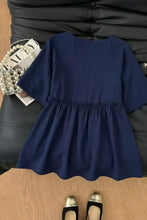 Navy blue short-sleeved a-line dress with gathered waist and subtle ruffled hem for elegant wear