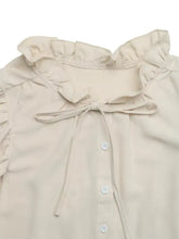 Beige ruffle sleeve tie neck shirt featuring a ruffled collar and matching tie detail in soft fabric