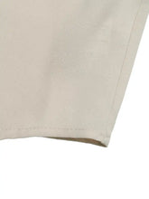 Beige cotton ruffle sleeve tie-neck shirt showing neat straight stitching along the hem