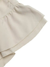 Beige ruffle sleeve tie-neck shirt with soft flowing fabric and neat stitching along the hem