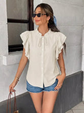 Off-white ruffle sleeve tie-neck blouse with button-down front and short ruffled sleeves in lightweight fabric