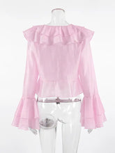 A delicate pink ruffle trimmed long sleeve blouse with layered ruffles at the neckline and flared sleeves