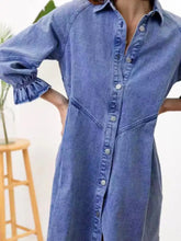 A medium-wash blue denim dress with button closures and ruffled cuff button-down detail for casual wear