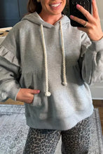 Gray oversized ruffled drawstring long sleeve hoodie with cream rope drawstrings designed to machine wash cold