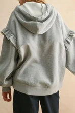 A soft heather gray ruffled drawstring long sleeve hoodie with matching hood machine wash cold recommended