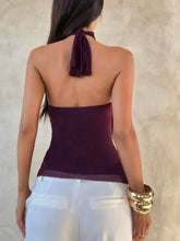 A deep purple ruffled halter neck cami featuring a tied-back neckband and sheer fabric at the bottom