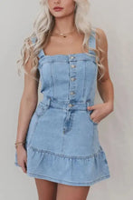 Light blue denim dress with square neck, button front closure, and ruffled hem detail for stylish wear