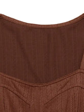 Brown textured knit dress with geometric patterns and fitted neckline
