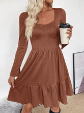 Ruffled hem long sleeve knit dress in cozy rust-colored ribbed fabric