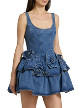 Blue denim dress with layered scoop neck and ruffled floral embellishments in a mini silhouette