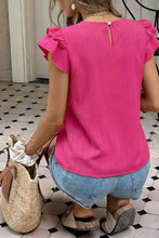 Fuchsia pink ruffled round neck blouse with subtle vertical ribbed texture and back neckline button detail shown from back