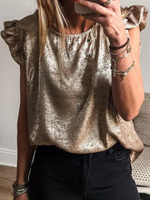 A shimmering gold metallic ruffled round neck tank with short sleeves and a relaxed fit for elegant wear