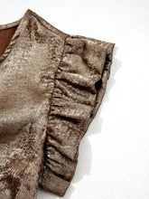 A shimmering bronze velvet ruffled round neck tank with detailed ruffled sleeve accents
