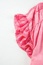 A vibrant pink ruffled sleeve with subtle sheen on a soft fabric in a ruffled short sleeve buttoned denim mini dress
