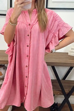 A soft pink button-front denim mini dress with ruffled short sleeves and a relaxed fit perfect for casual wear
