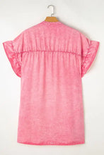 A soft pink cotton mini dress with ruffled short sleeves and a gathered waistline, styled as a denim mini dress