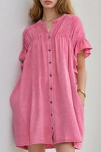 A soft pink denim mini dress with ruffled short sleeves and a buttoned front for casual wear