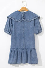 A soft blue denim mini dress with puffed short sleeves and ruffled collar and hem detailing