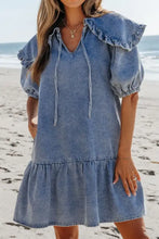 Denim mini dress with v-neck, ruffled collar, puff sleeves, and side pockets in blue denim material