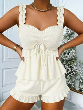 Ruffled smocked cream romper with ruffled tiers and smocked bodice