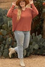 Rust notched long sleeve V-neck top with relaxed fit and ribbed cuffs