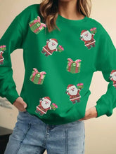 Green christmas-themed sequin sweatshirt featuring santa delivering gifts machine wash cold for easy care