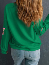 Green long-sleeved sweatshirt with embroidered holiday patches for christmas wear machine wash cold recommended