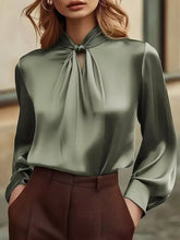 A sleek olive green satin cutout front blouse with high neck and tied knot detail for elegant wear