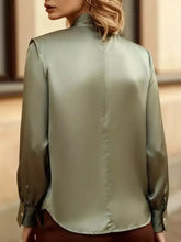A sleek olive green satin cutout front blouse with a high collar and long sleeves for elegant wear