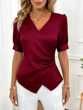 A sleek deep red satin v neck wrap blouse with short puffed sleeves and a stylish neck wrap design