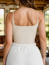 Beige scoop neck cami bodysuit with spaghetti straps square neckline and elastic waistband for comfortable fit