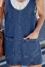 Blue denim sleeveless scoop neck dress with front pockets made of durable denim suitable for machine wash care instructions