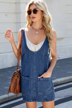 Scoop neck denim overall dress in blue with white lace trim and front pockets machine wash care instructions included