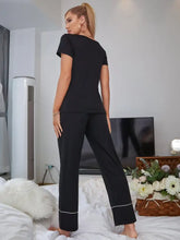 Black scoop neck top and elastic waist pants lounge set with long sleeve length and white trim at the cuffs