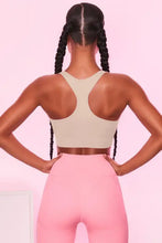 Beige scoop neck wide strap active bra with pink high-waisted leggings and brown waistband for bust support