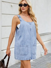 Light blue denim dress with scoop neck wide strap and square neckline featuring two front pockets