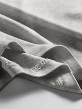 Soft gray scoop neck wide strap tank made of knit fabric with delicate lace trim along the edge