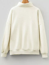 Cream-colored oversized fleece sweatshirt with high collar and ribbed cuffs sequin candy canes patchwork machine wash tumble dry care instructions